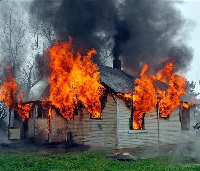 house on fire, flames out windows, smoke
